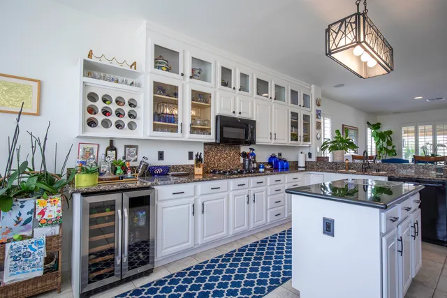 a kitchen with stainless steel appliances a sink and cabinets