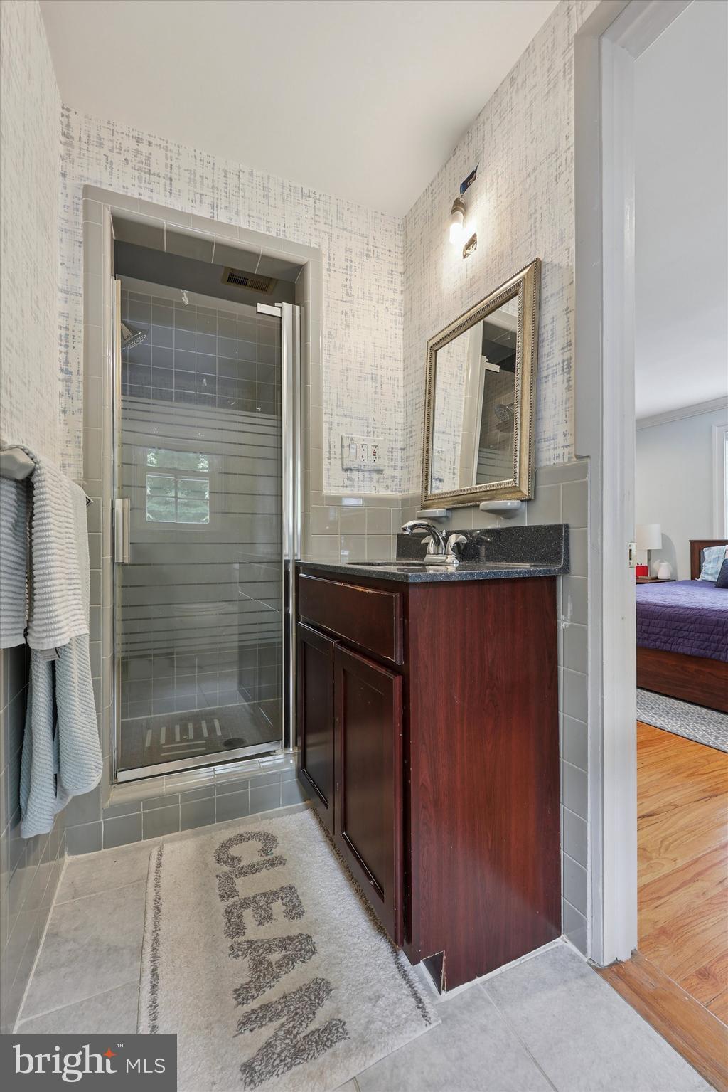280 Deepdale Road Wayne, PA 19087 - Photo 22 of 35 a bathroom with a granite countertop sink a mirror and shower