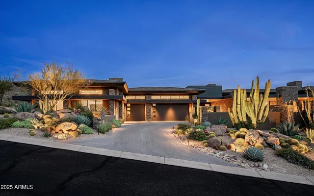 a living room with furniture potted plant and a large window