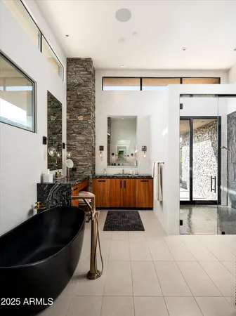 a living room with furniture a fireplace a flat screen tv and a large window