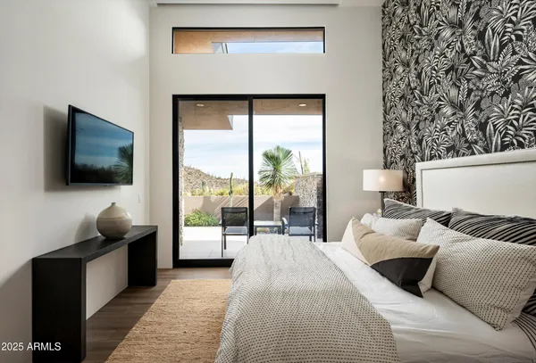 a living room with furniture a fireplace and a floor to ceiling window