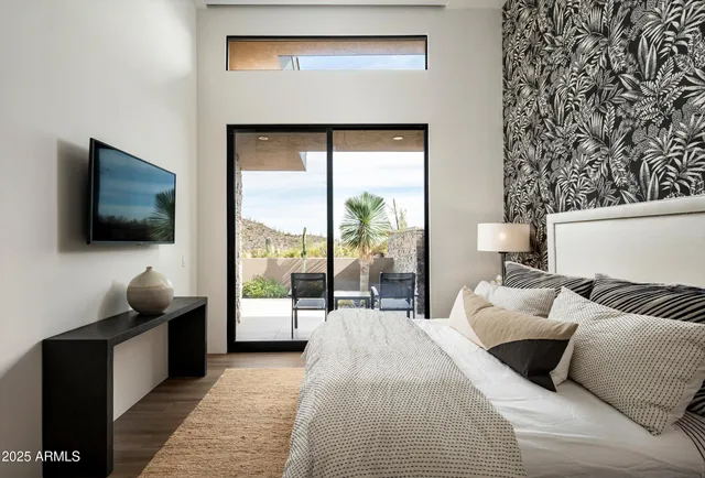 a living room with furniture a fireplace and a floor to ceiling window