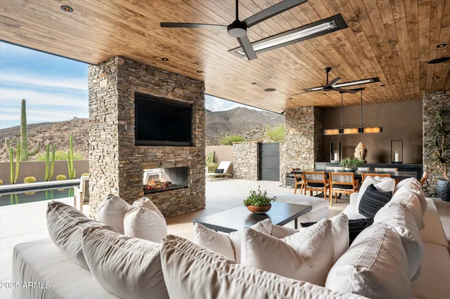 a view of a dry yard with mountains in the background