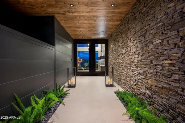 a bedroom with furniture and a large window