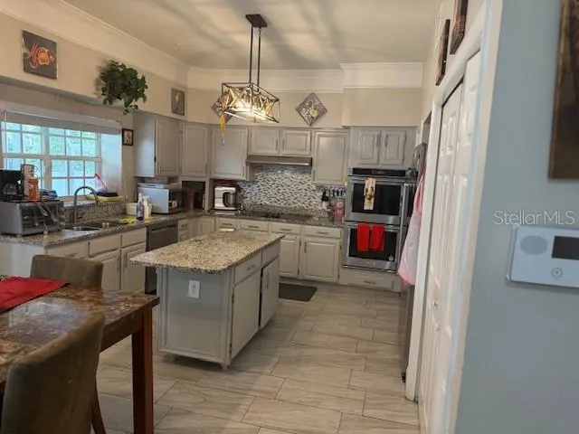 a kitchen that has a lot of cabinets in it