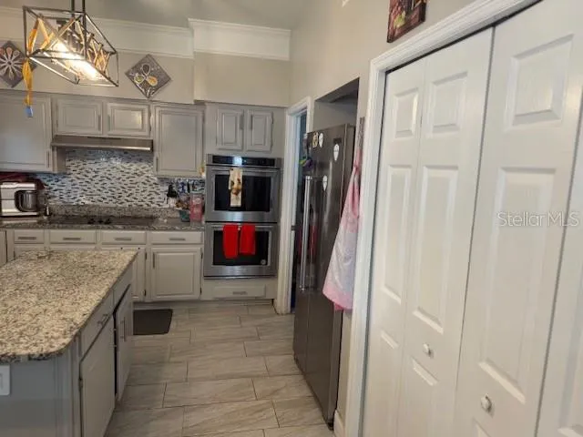 a kitchen with refrigerator and cabinets