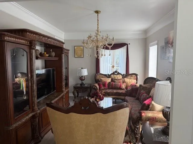 a living room with furniture and a chandelier