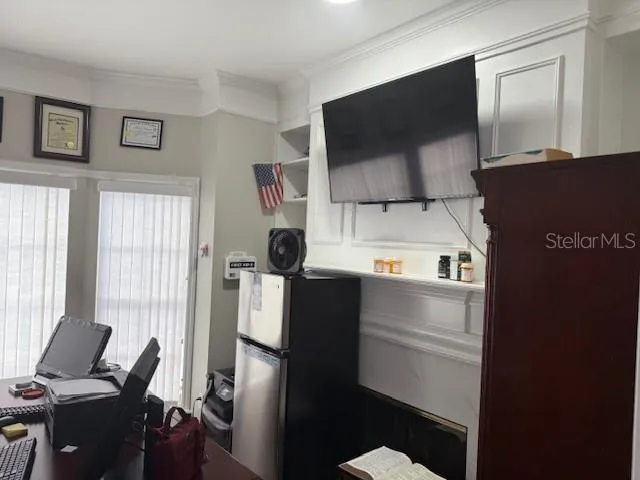 a kitchen with a refrigerator and a stove top oven