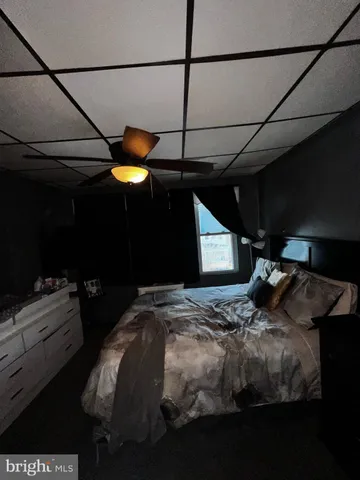 a bedroom with a bed and a mirror