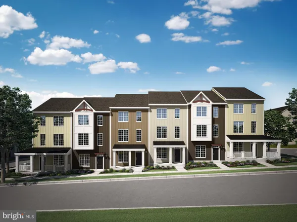 a front view of a residential apartment building with a yard
