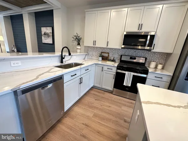 a kitchen with a sink stove and microwave