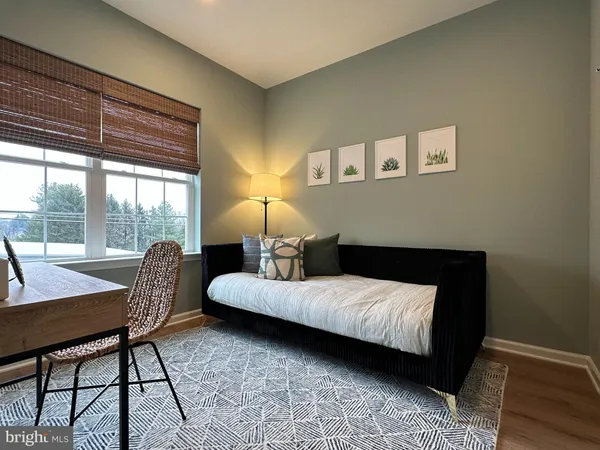 a bedroom with a bed chair and a window