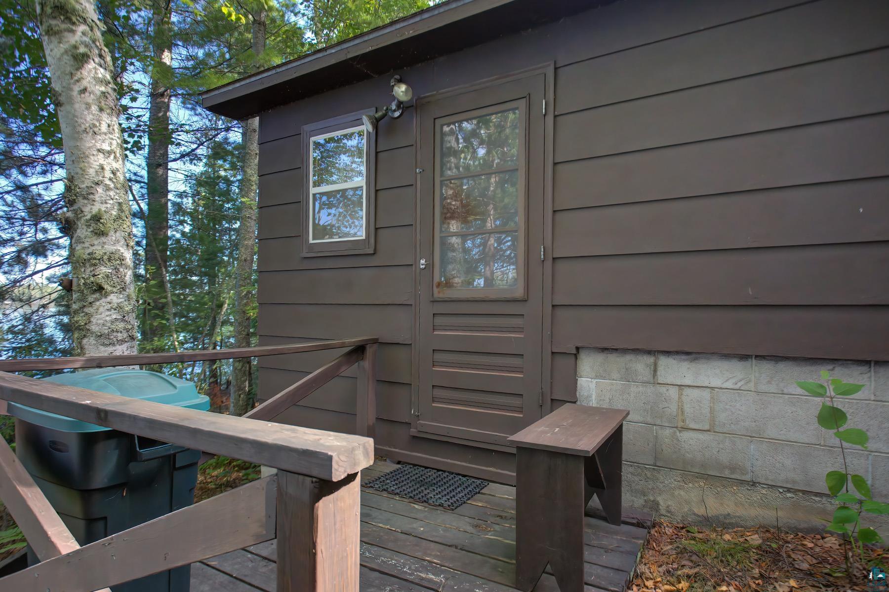2815 Schaeffer Road Ely, MN 55731 - Photo 21 of 37 Brown siding exterior with a wood deck and railing