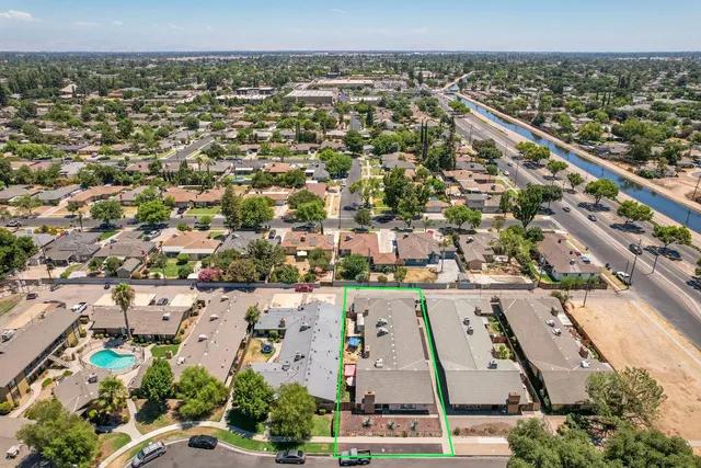 an aerial view of residential houses with outdoor space