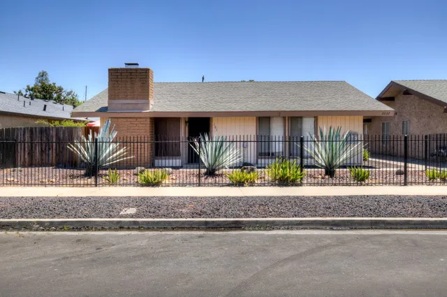 a front view of a house with sitting area