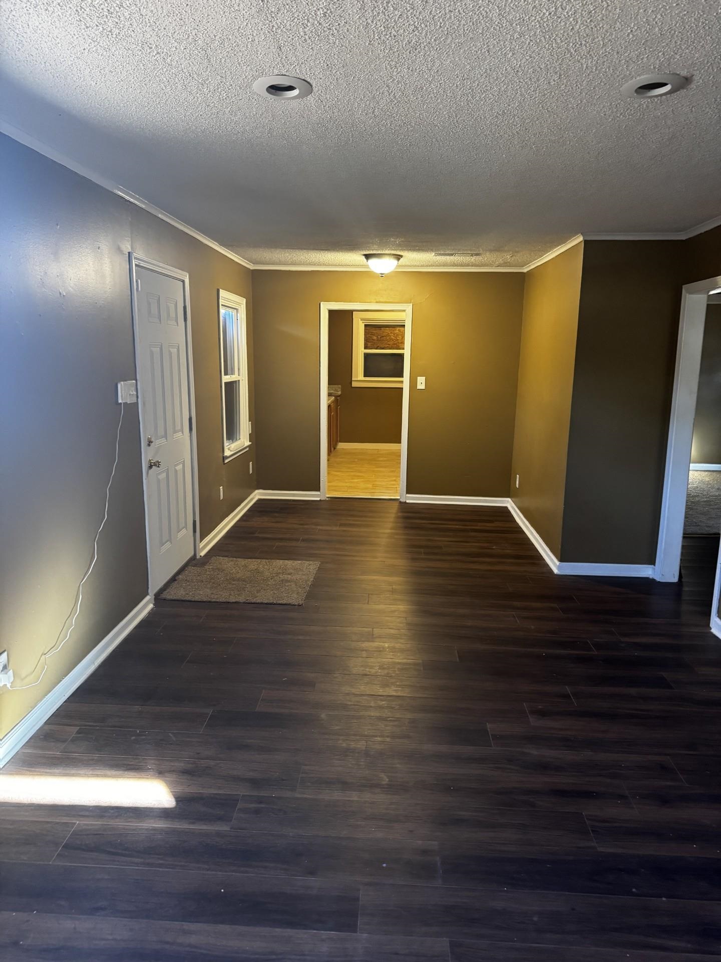 3271 Seminole Road Memphis, TN 38111 - Photo 2 of 8 a view of an empty room with wooden floor and a window