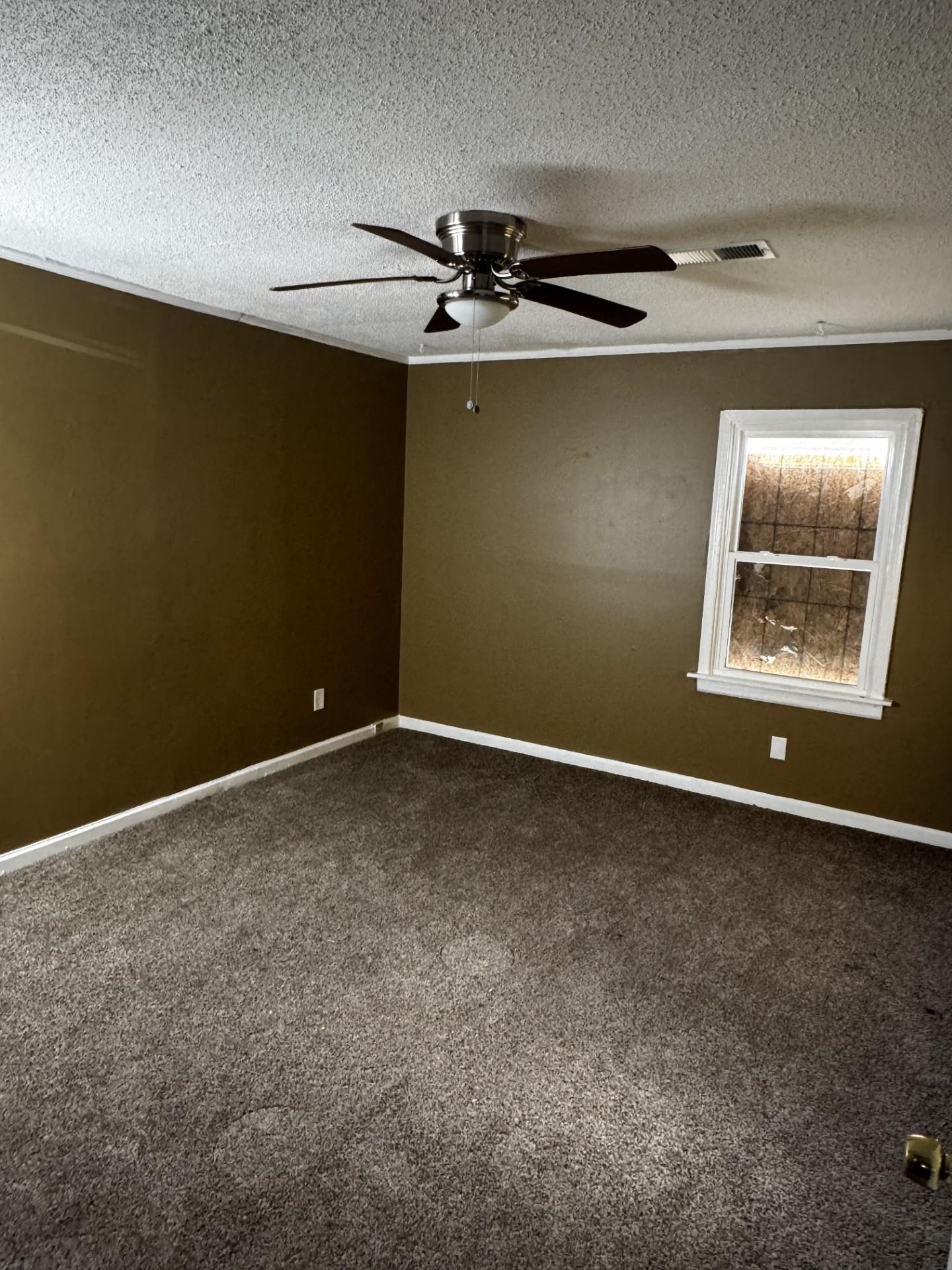 3271 Seminole Road Memphis, TN 38111 - Photo 4 of 8 an empty room with windows and fan