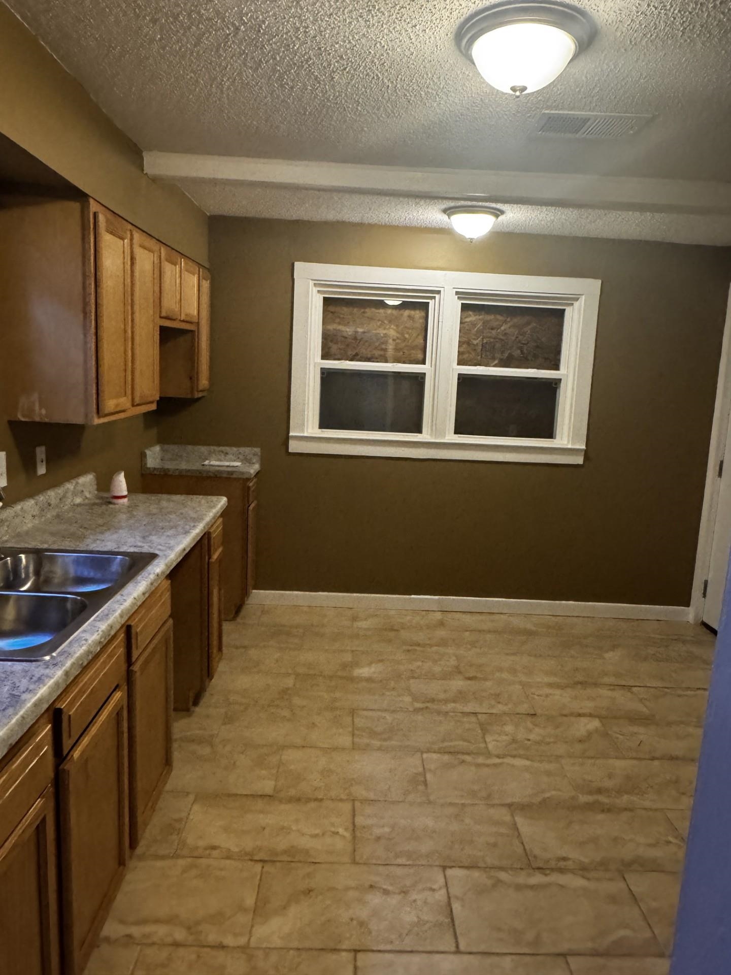 3271 Seminole Road Memphis, TN 38111 - Photo 5 of 8 a kitchen with stainless steel appliances granite countertop a sink stove and cabinets