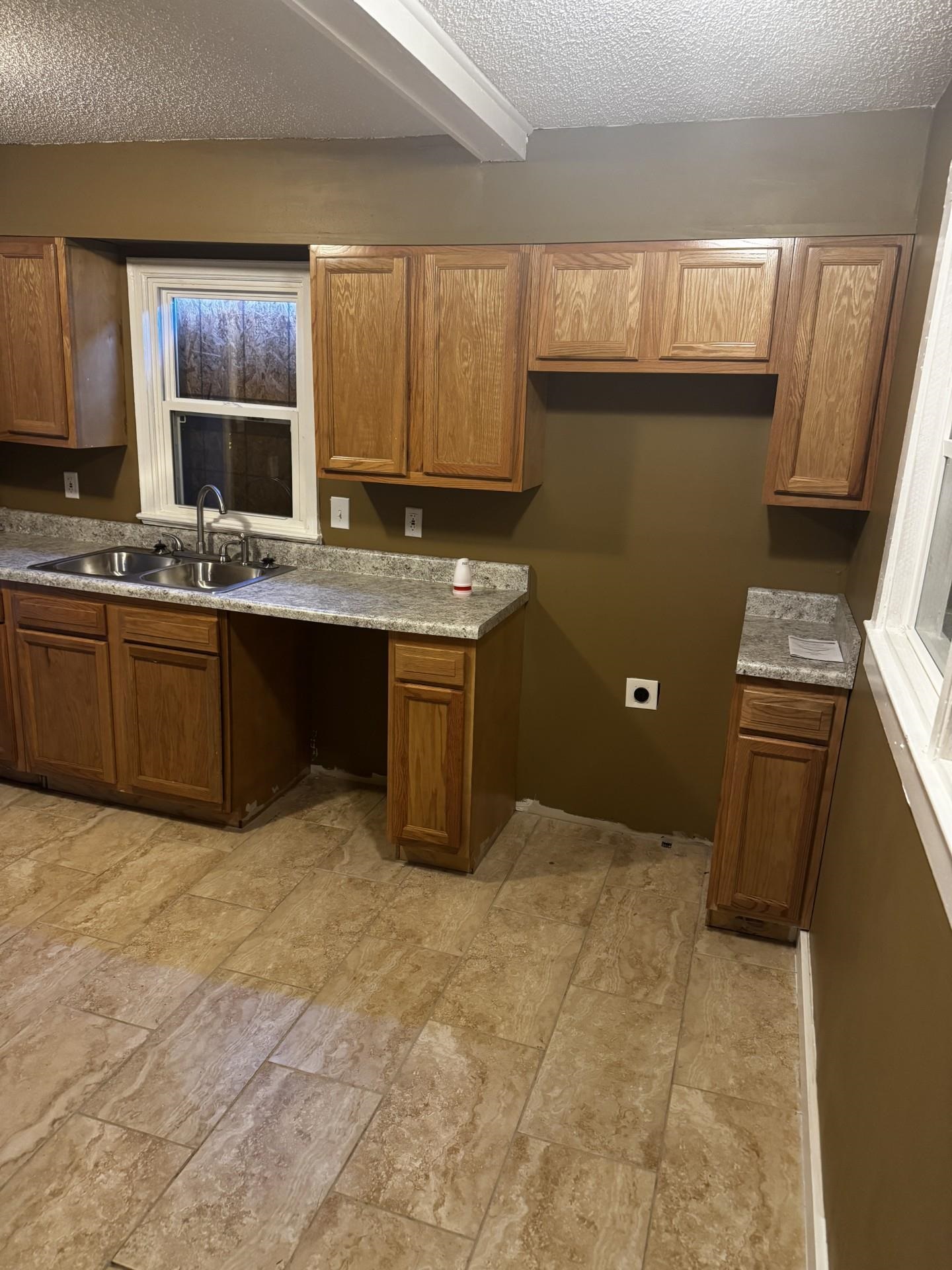 3271 Seminole Road Memphis, TN 38111 - Photo 6 of 8 a kitchen with granite countertop a sink cabinets and window