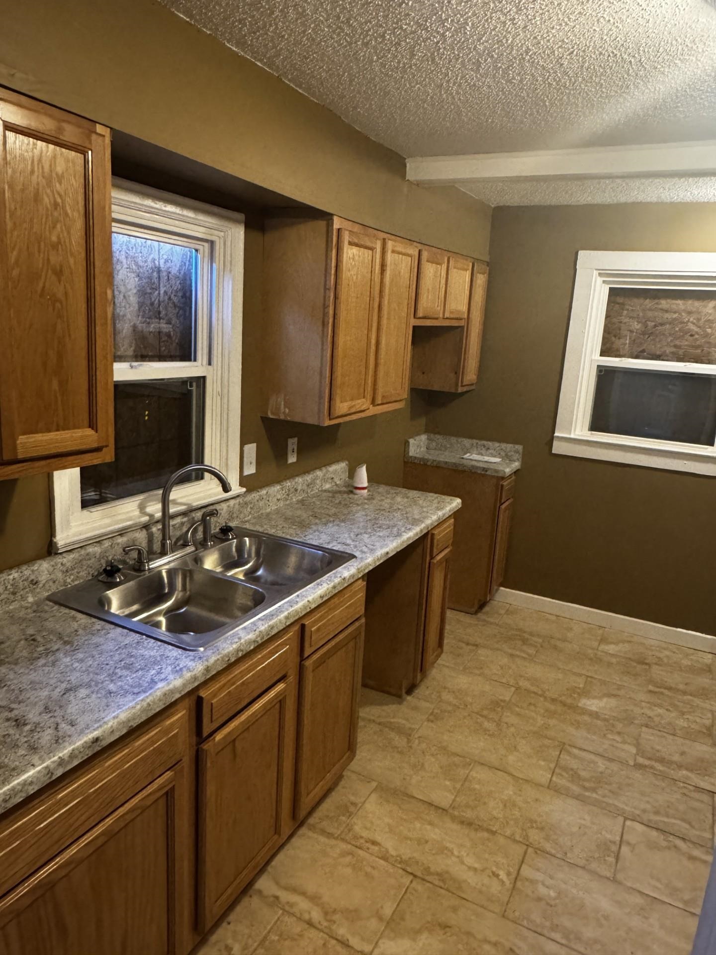 3271 Seminole Road Memphis, TN 38111 - Photo 7 of 8 a kitchen with a sink stove and cabinets