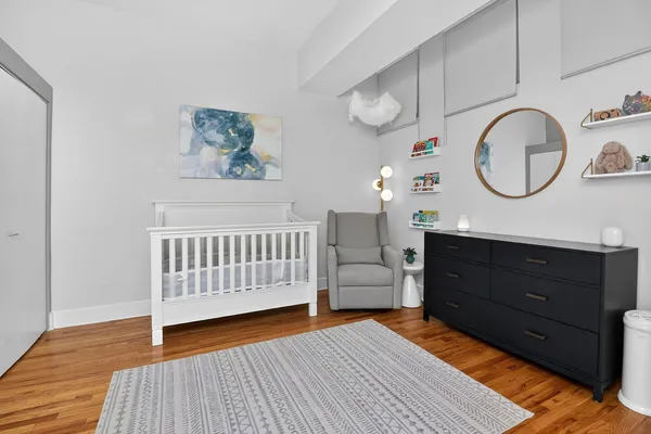 a bedroom with a bed and painting on the wall