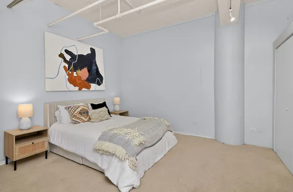 a bedroom with a bed and a desk