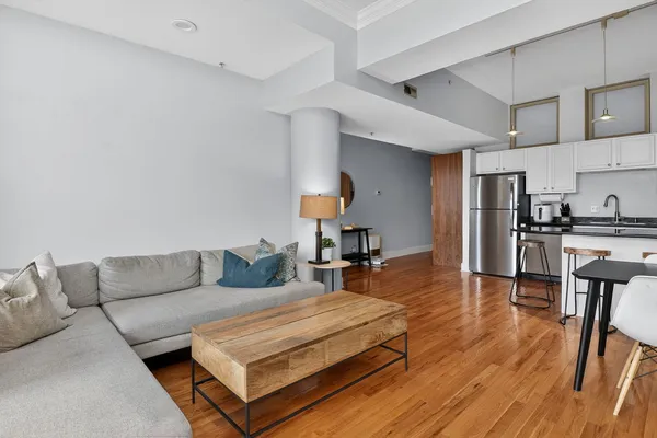 a living room with furniture a flat screen tv and a fireplace