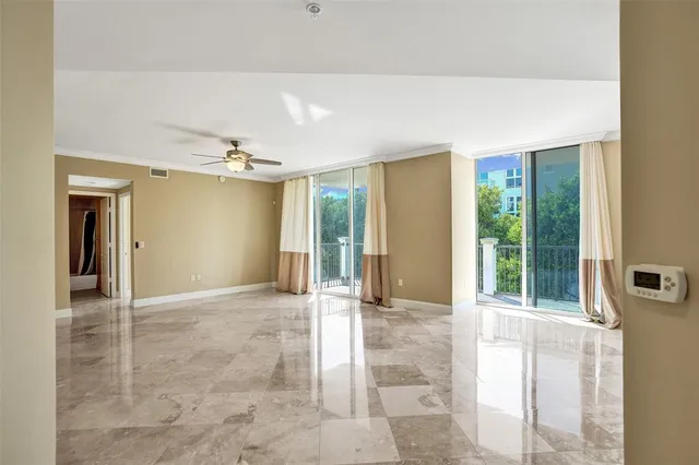 a view of a hallway with a chandelier fan