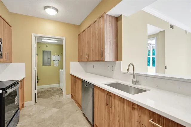 a view of a big room with a windows and ceiling fan