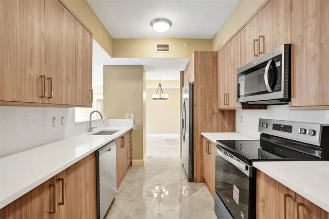 a view of a big room with windows and ceiling fan