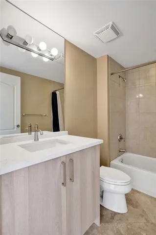 a view of a hallway with a chandelier fan