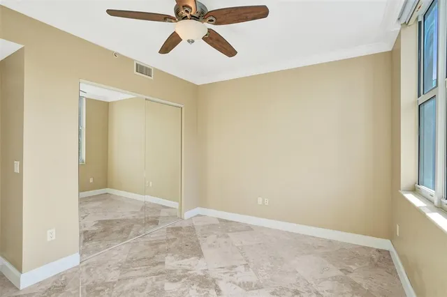 a view of a room with a chandelier fan