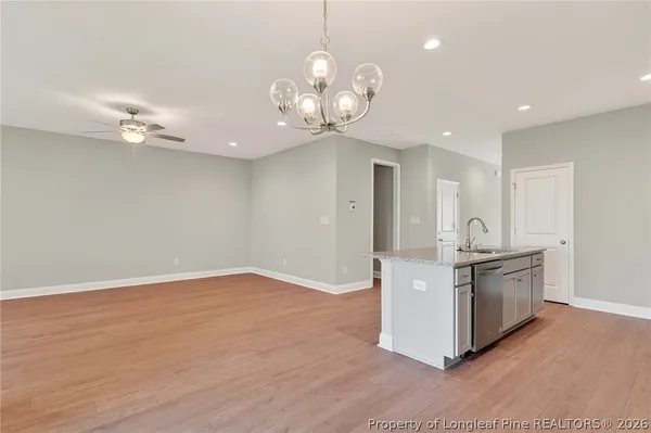 a kitchen with stainless steel appliances granite countertop a stove and cabinets