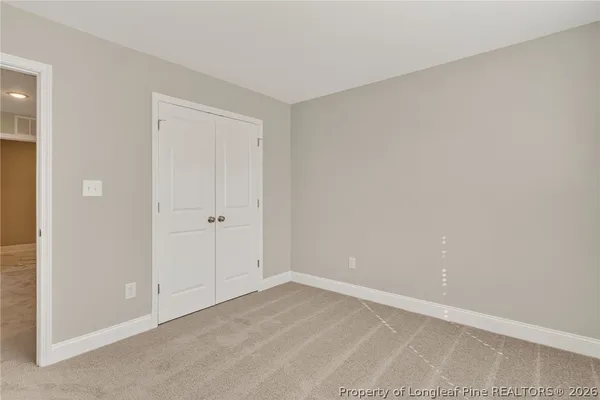 a view of an empty room and closet area