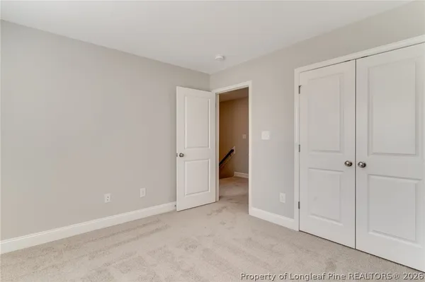 a view of a room with windows and ceiling fan