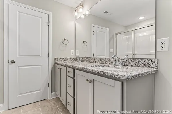 a bathroom with a glass shower door