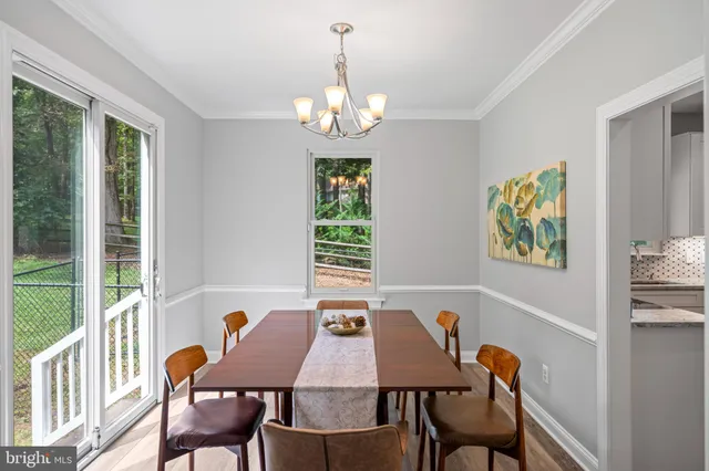 a view of a dining room with furniture and a chandelier