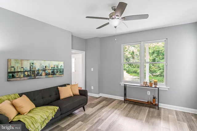 a living room with furniture a fireplace and a large window