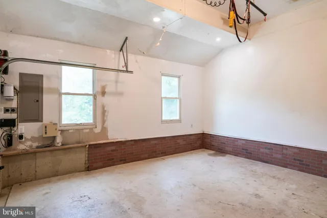 a view of a lush green forest with a building in the background