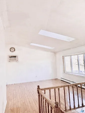 a view of a room with wooden floor and windows