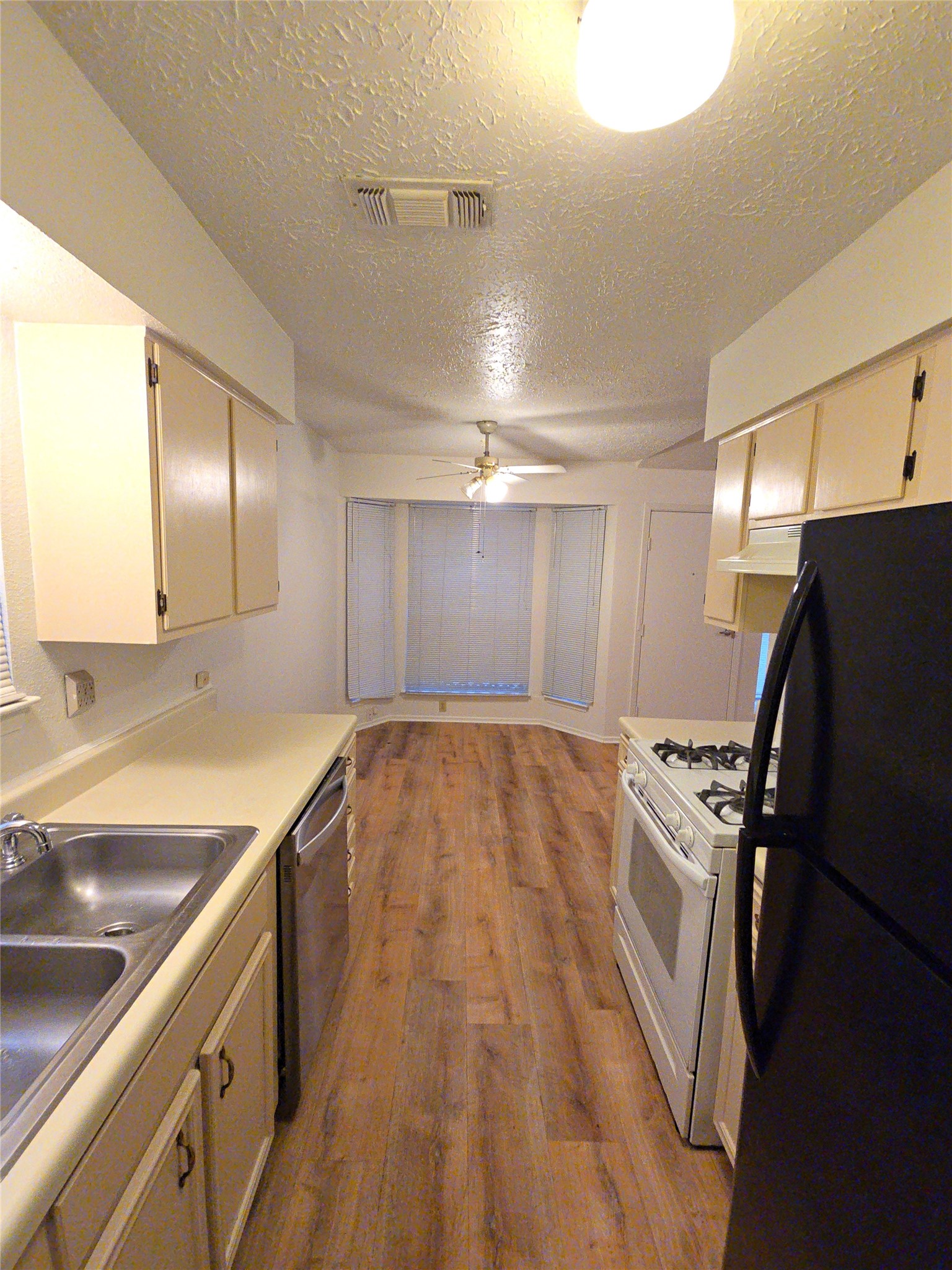 10906 Maple Rock Drive Humble, TX 77396 - Photo 15 of 27 a view of a kitchen with a sink and refrigerator