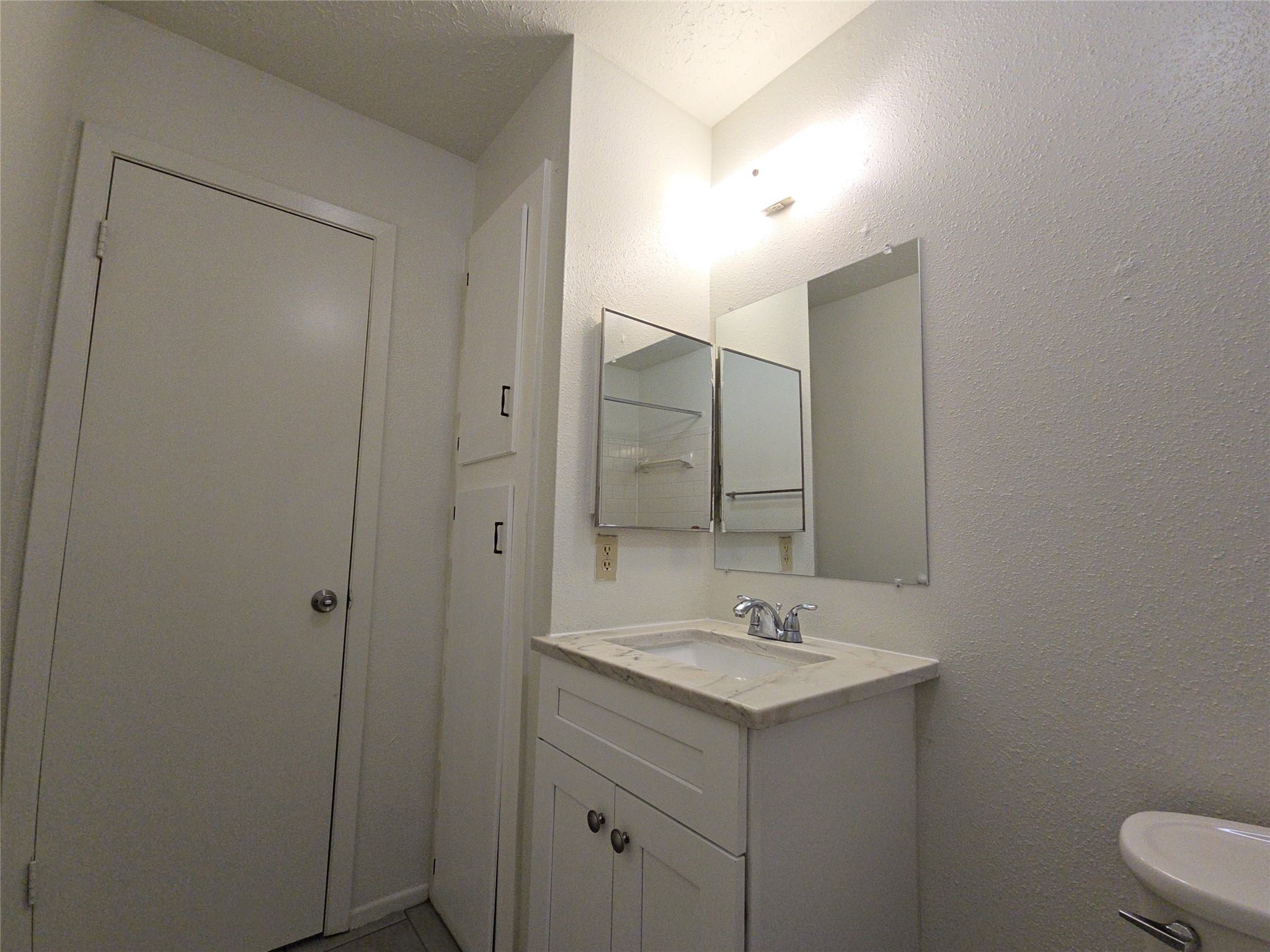 10906 Maple Rock Drive Humble, TX 77396 - Photo 16 of 27 a bathroom with a sink a toilet and a mirror