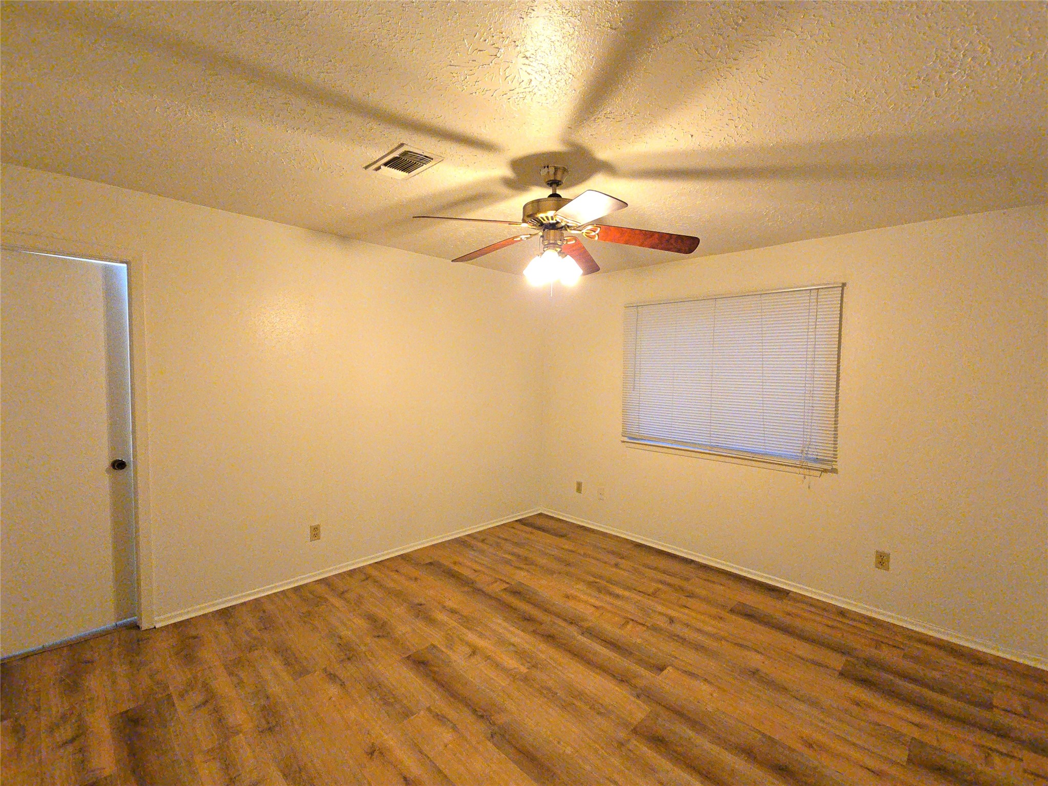 10906 Maple Rock Drive Humble, TX 77396 - Photo 7 of 27 a view of empty room with wooden floor
