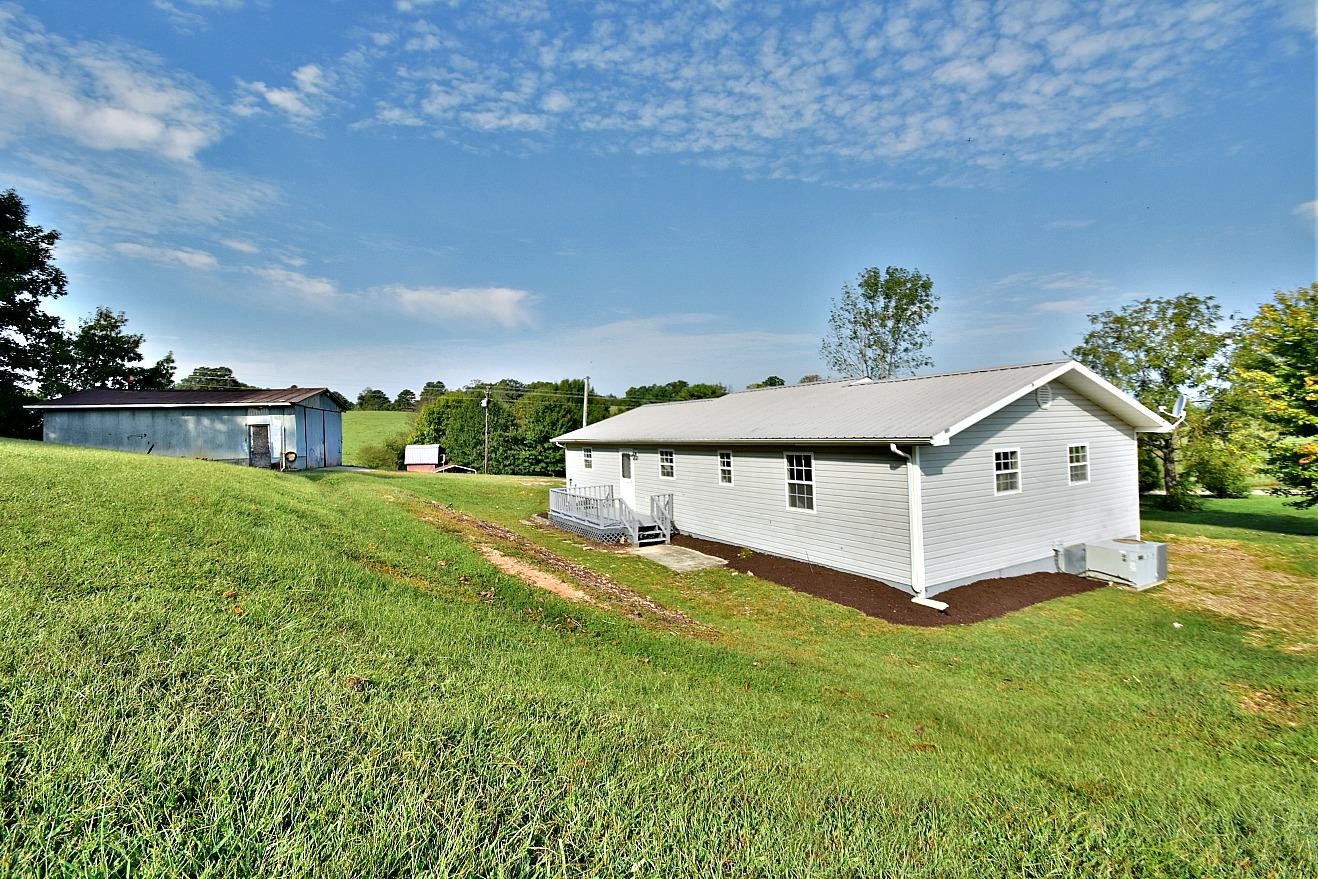 2880 Oakland Road Philadelphia, TN 37846 - Photo 19 of 27 a white house with a big yard and large trees