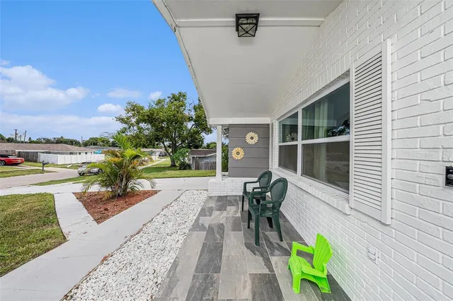 a view of a patio with a table and chairs