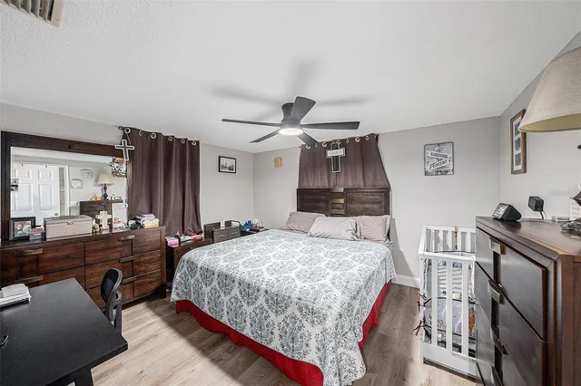 a bedroom with a bed a couch and dresser