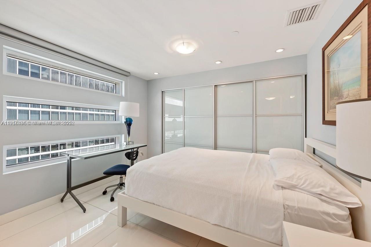 1040 Biscayne Boulevard, Unit 4403 Miami, FL 33132 - Photo 11 of 31 a bedroom with a bed and a dresser