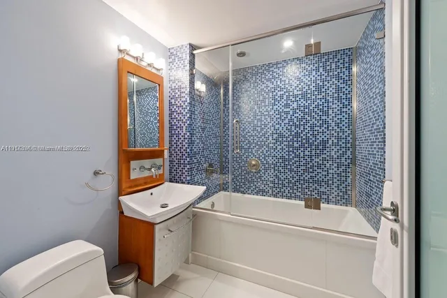 a bathroom with a bathtub toilet and shower