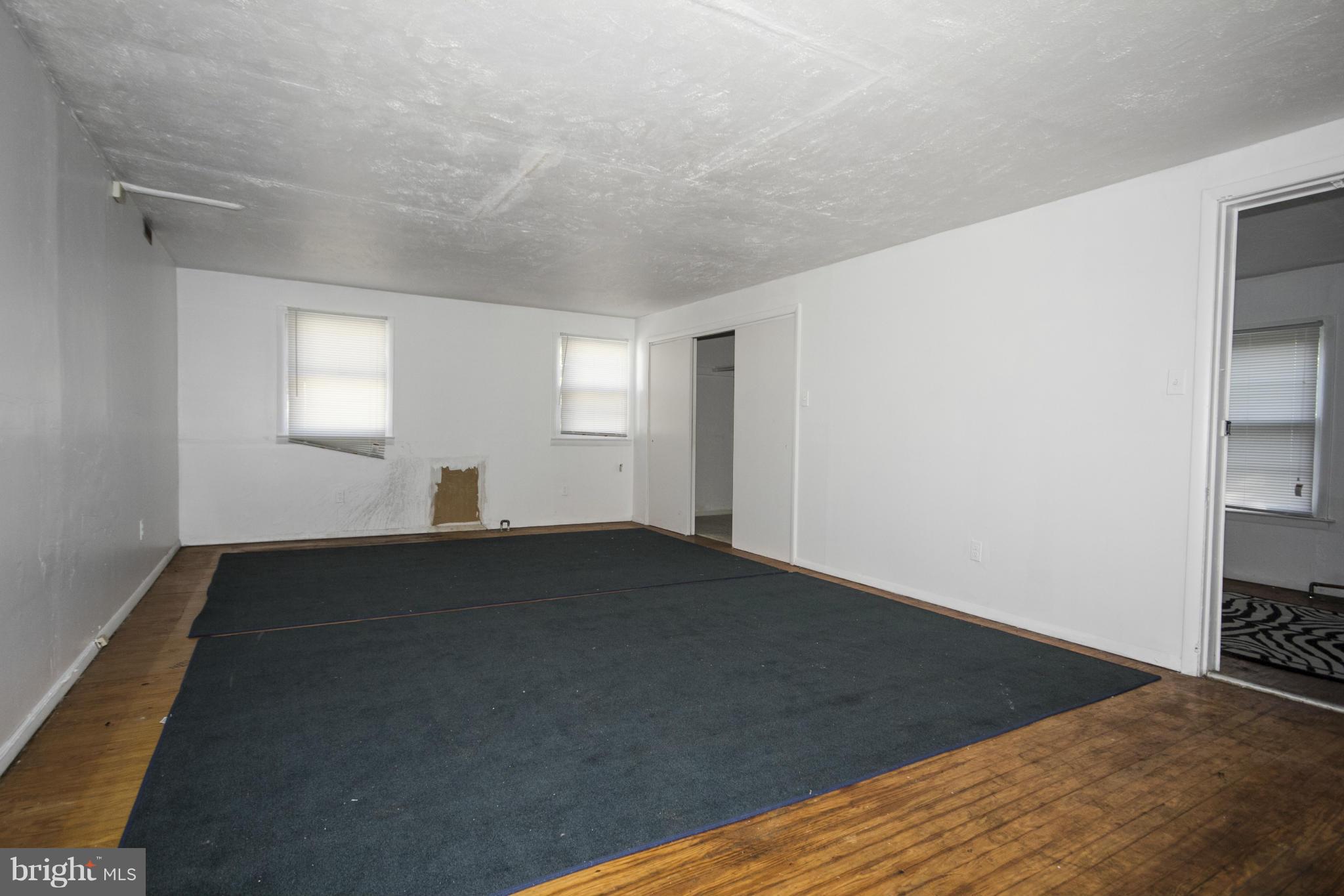 1803 Chelsea Road Baltimore, MD 21216 - Photo 18 of 30 a view of empty room with wooden floor and fan