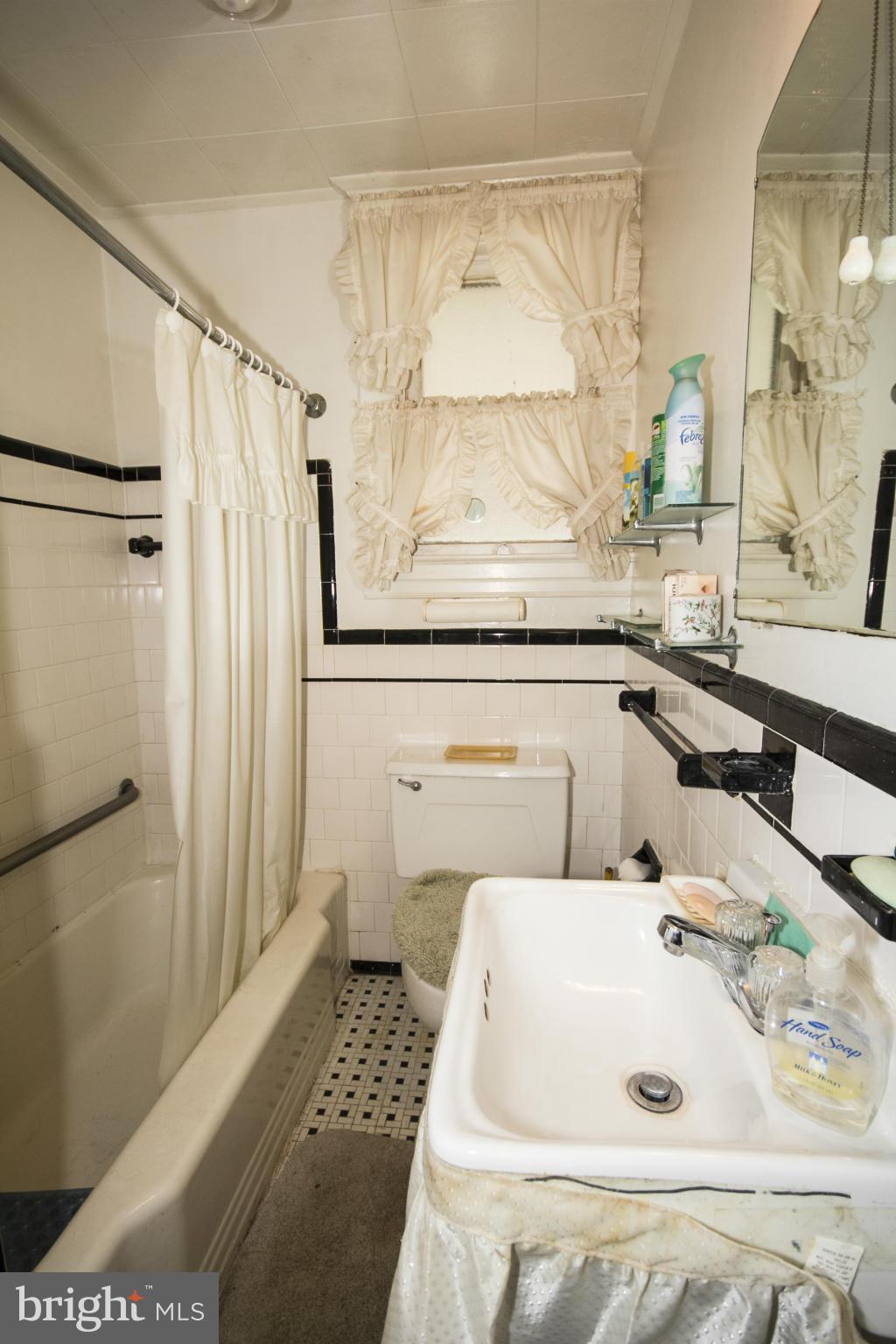 1803 Chelsea Road Baltimore, MD 21216 - Photo 23 of 30 a bathroom with a sink and a mirror